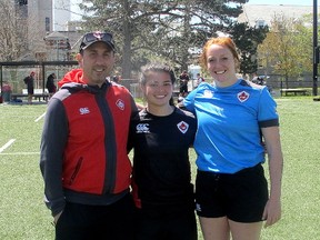 Newly appointed head coach of Canadian women’s rugby team, Sandro Fiorino, left, joins East Camp attendees Annie Kennedy of Kingston and Queen's Gaels alumni Lauren McEwen at Queen’s University’s Nixon Field on Friday. (Sebastian Bron/The Whig-Standard)