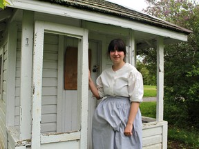 Historic interpreter Celine Vereecken stands at the playhouse once used by Hazel (Budd) Backus, when she was a child growing up at the Backus Family Homestead located at the Backus Heritage Conservation Area, near Port Rowan, in Norfolk County. (Michelle Ruby/The Expositor)
