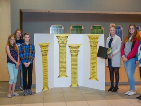 Students Sonia Van der Burgh, Cierra Burk, Matthew Belsham, and Logan Cook-Bowes pose with Principal Cathy Ziegler and Assistant Principal Stacy Pothier of Ecole Airdrie Middle School pose together in front of the school's Falcon Values on Thurs., May 17.
