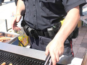 Const. Troy Miller, of Sault Ste. Marie Police Service, works the grill during a barbecue on Wednesday to promote HOPE alliance.