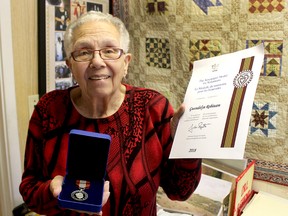 Gwen Robinson displays the Sovereign's Medal for Volunteers and accompanying certificate she received in the mail on Wednesday May 23, 2018. Ellwood Shreve/Chatham Daily News/Postmedia Network