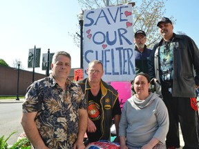 Pastor Randy Kennedy, left, with his longtime ally and emergency shelter volunteer Ray Botten, with shelter residents Melissa Farrar, Ian MacLellan and Wayne Flett, right, on Wednesday. The Victorious Living Centre and its shelter were ordered to vacate the building at 748 2nd Ave. E. by court order by Wednesday but by late afternoon, the order hadn't been enforced and these residents said the weren't leaving. (Scott Dunn/The Sun Times)