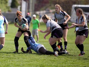 Kenna McKee looks for an outlet as she tries to free her leg from a tackler. McKee and the Owen Sound District Wolves beat Kitchener's St. Mary's, 42-5, on Wednesday afternoon in the CWOSSA AAA finals in Owen Sound. Greg Cowan/The Sun Times