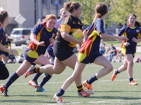 La Salle Black Knights’ Avery Comeau breaks away from Napanee Golden Hawks players during the second half of the Kingston Area Secondary Schools Athletic Association girls rugby championship game at Nixon Field on Wednesday. The Knights won 19-7 and will be playing in the Eastern Ontario Secondary Schools Athletic Association championship next Tuesday. (Julia McKay/The Whig-Standard)