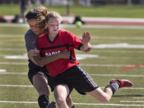 Layla Yunes of Assumption College tries to stop Taylor Schell of Paris District High School from passing the ball during the high school girls soccer championship game on Wednesday at Bisons Alumni North Park Sports Complex in Brantford. (Brian Thompson/The Expositor)