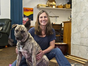 Susanne Currie sits with her dog, Zeke, in the Healing Room at Amani in Jerseyville. (Brian Thompson/The Expositor)