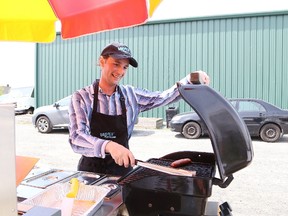 Don Leblanc, of the Sudbury Food Bank's hotdog and sausage cart, prepares a sausage for a customer outside the Sudbury Food Bank location in Sudbury, Ont. on Wednesday May 23, 2018. John Lappa/Sudbury Star/Postmedia Network