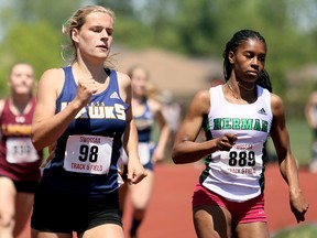 Payton Sabourin, left, of Chatham-Kent is challenged by Taneidra Cain of Herman during the senior girls' 400 metres at the SWOSSAA track and field championship at the Chatham-Kent Community Athletic Complex in Chatham, Ont., on Wednesday, May 23, 2018. (MARK MALONE/Chatham Daily News/Postmedia Network)