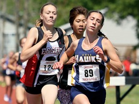 Emma Pegg (89) of Chatham-Kent begins pulling away from Lily Pattinson of Windsor Riverside and Taylor Campeau of Essex on the final lap of the midget girls' 1,500 metres during the SWOSSAA track and field championship at the Chatham-Kent Community Athletic Complex in Chatham, Ont., on Wednesday, May 23, 2018. Pegg won in 5:03.29. Mark Malone/Chatham Daily News/Postmedia Network