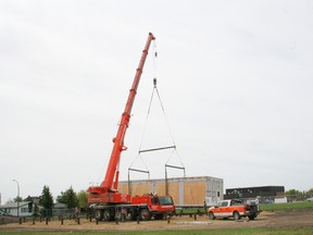 The LaPrairie Crane lifts the first of the modules for the new Child's World Daycare building into place at the building site just east of EE Oliver School Monday, May 14. Only five more modules to go. By May 16, all of the modules were in place and now contractors can begin work on the finishing touches.