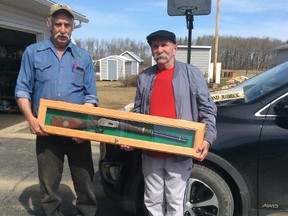 The lucky winner of the Saskatchewan Diamond Jubilee Rifle is Brian Law of Taylor BC. Pictured is Dennis Lof of Dunvegan Fish & Game Assn.(left) presenting the the gun to Brian (right).