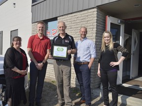 The owners of H.D. painting were recognized Thursday for their emphasis on living wage, a concept championed locally by Living Wage Elgin-St. Thomas. From left, primary estimator Tina Cloes, owner Jon Dryfhout, owner and founder Henry Dryfhout, owner Josh Dryfout, and human resource manager Kaitlyn VanHouwelingen stand outside the company's St. Thomas headquarters. (Louis Pin/Times-Journal)