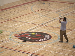 Paint crews admire their work in St. André Bessette’s large gym. Elk Island Catholic Schools held a open house to the public on May 16.
