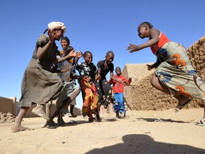 Malian girls sing and play in the northern city of Gao, a key Islamist stronghold until it was retaken on Jan. 26, 2013, by French and Malian troops in a major boost to the French-led offensive against the al-Qaida-linked rebels, who had held Mali's vast desert north since April 2012. (SIA KAMBOU/Getty Images)