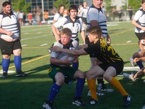 Gordon Anderson/Daily Herald-Tribune
Aidan McGladdery of the Peace Wapiti Academy Titans (left) and Thomas Odland of the Charles Spencer Mavericks collide during the first half of the Peace Country High School Rugby 15s semifinal at CKC Field on Wednesday evening. The Mavericks grabbed a 22-7 win and head to the final against the St. Joseph Catholic High School Celtics. The championship game is set for May 30 at Macklin Field. Game time is 7:15 p.m.