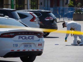 Police forensic officers work around the scene where an IED ripped through a Mississauga, Ont., restaurant early Friday morning, on Friday, May 25, 2018. THE CANADIAN PRESS/Cole Burston