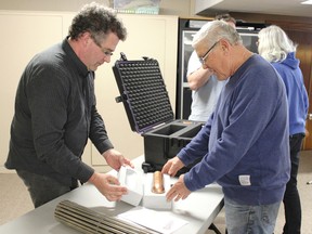 NWMO environmental engineer and geoscientist Dylan Luhowy discusses models of fuel bundle protection with HFFN member Bob Simpson.