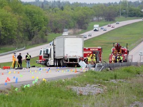 Investigators probe the scene of a fatal crash that took place on Highway 401 between County Road 6 and Gardiners Road in Kingston, Ont. on Friday May 25, 2018. Steph Crosier/The Whig-Standard/Postmedia Network