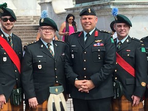 Dr. Kevin McCormick (second from left), president of Huntington University and an honourary lieutenant colonel of the Irish Regiment of Canada, and John Valtonen (second from right), an inspector with the Greater Sudbury Police Service and a colonel with the Irish Regiment, as well as 10 soldiers and their partners attended a garden party Tuesday at Buckingham Palace in honour of HRH Prince Charles' 70th birthday. Flanking the two are members of the Irish Regiment of Canada. (supplied photo)