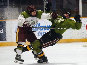 Dryden Rivet, of North Bay, gets the better of an unidentified North Bay Battalion prospect during a spring evaluation camp scrimmage at Memorial Gardens, Saturday. The a second white and green game is scheduled Sunday at 9 a.m. Dave Dale / The Nugget