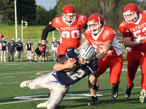 Sudbury Spartans quarterback Hunter Holub (12) is tackled by Steel City Patriots' Josh Garrick (52) during Northern Football Conference action at James Jerome Sports Complex in Sudbury, Ont. on Saturday, May 26, 2018. Ben Leeson/The Subdury Star/Postmedia Network