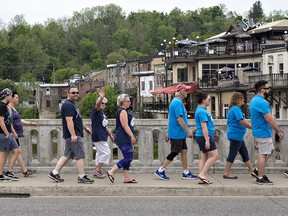 Participants in the Walk for Alzheimer's fundraiser cross the William Street bridge in downtown Paris on Saturday. (Brian Thompson/The Expositor)