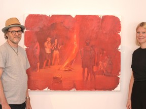 Artist Tom Campbell and Helene Fuchshuber, a Rotary International exchange program participant from Germany who helped curate Agora Gallery’s summer exhibition, pose next to one of Campbell’s pieces on display, entitled Red Fire. (Galen Simmons/The Beacon Herald/Postmedia Network)