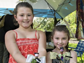 Evangaline D'Andrea (left), 9, and her six-year-old sister, Karoleena, show the African angels they made on Sunday at the Glenhyrst Family Arts Day in Brantford. (Brian Thompson/The Expositor)