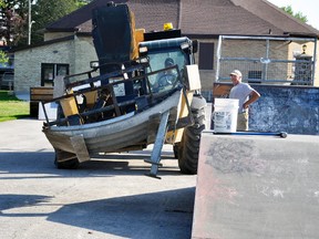 Under the watchful eye of Paul Krempien (right), son Joel guides this concrete ramp in place at the West Perth All-Wheels Park in Mitchell last Friday, May 25. “New” concrete ramps were installed in the park, having been moved from Stratford. ANDY BADER/MITCHELL ADVOCATE
