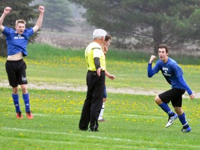 Curtis Lockhart (right) of the MDHS varsity boys soccer team pumps his fist in celebration after scoring on a header off a cross during Huron-Perth regular season action against Central Huron May 22, a 1-1 draw. Also pictured is Ryan Bell (left). ANDY BADER/MITCHELL ADVOCATE