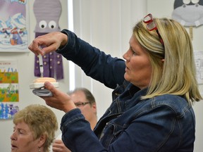Stacy Dickerson, HIV West Yellowhead's prevention and engagement coordinator, draws one millilitre of water from the vials and administer it into a fake muscle. (Taryn Brandell | Whitecourt Star)