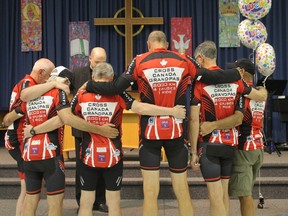 The Cross Canada Grampas bow their heads while Rev. David Matthews says a prayer during their launch event on May 23.
CARL HNATYSHYN/SARNIA THIS WEEK