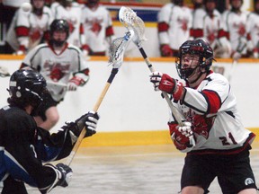 Wallaceburg Red Devil Tyler Davis fights for a loose ball during a game against the London Blue Devils at Wallaceburg Memorial Arena on Saturday, May 26.