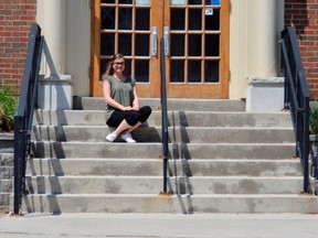 Rowan Miller sits on the steps of the YWCA in St. Thomas where, three years ago, she found refuge as an 18-year-old high school student without a stable home. Today Miller is living with a group of other young women in St. Thomas and will start a new program at Fanshawe College in the fall. (Louis Pin/Times-Journal)
