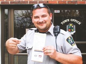 Justin Vallee, community peace officer for the Town of Vulcan holds up his positive ticketing book just outside the front doors of the Town office, May 17. Jasmine O’Halloran Vulcan Advocate