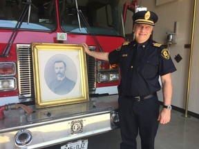 Fire Chief Bob Davidson shows off the portrait of Herman Ponsford, who died fighting a St. Thomas fire in 1887. The portrait was donated by Ponsford’s family recently and will be hung in a prominent place at the Wellington Street fire station. (Laura Broadley/Times-Journal)