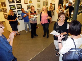 Lake of the Woods Museum director Lori Nelson congratulates a participant on her winning bid during the reception for the Silent Art Auction fundraiser in support of the new art centre on Friday, May 25.
Reg Clayton/Daily Miner and News