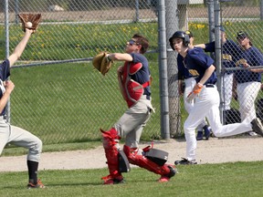 St. Mary's Warriors Jarvis Otto, left, catches a fly in their game against London's Regina Mundi College in London, Ont. on Thursday May 17, 2018 at City Wide Field during their TVRA London District Catholic Division varsity baseball game. Regina Mundi won 5-4 with the Warriors finishing the regular season with a 2-3-1 record and start the playoffs next week. Greg Colgan/Woodstock Sentinel-Review/Postmedia Network