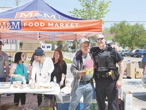 Left to right, Alan Poelman, CAS student, Meagan Collver, HOPE co-chair, Jackie, Neighbourhood Resource Centre volunteer, Taylar Piazza, HOPE co-chair, Darryl resident of Gore Street neighbourhood and City Police Const. Dave Doucette participate in the HOPE Alliance barbecue held on the weekend, an effort to spread the word that help is available for victims of human trafficking.
Allana Plaunt/Special to Sault This Week