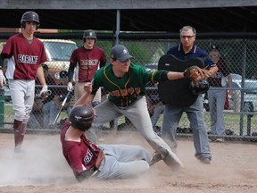 Nick Tessier, of the Algonquin Barons, slides into home as Scollard Hall Bears pitcher Kyle Backer catches the ball too late to make the tag as umpire Dave Saad and Algonquin's Kyle Kennedy watch the NDA high school baseball action at the Veterans Fields diamond, Monday.  It turned out to be the game-winning run as Algonquin, the defending champs, scored seven in the fifth inning to win 13-7. Dave Dale / The Nugget