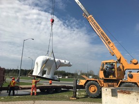 Crews under the direction of Infrastructure Services hoisted Chimo from his resting spot near the Board of Trade office. He will be replaced in the near future with the larger wooden structure that recently arrived in the community.