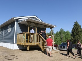 Visitors checked out one of three new tiny houses at Louis Bull May 23.