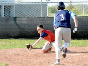 Red Sox catcher Tyler Marcotte reaches out in an attempt to catch a throw home as Blue Jays runner Darwin Mckay approaches the plate during the first inning of a Timmins Little League Junior/Senior Division contest at Parc Thériault Monday night. The throw skipped past Marcotte, allowing Mckay to score easily on the play. The Red Sox went on to thump the Blue Jays 15-5 in the first game in the new division.  THOMAS PERRY/THE DAILY PRESS