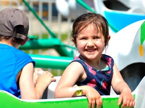 Lily Adam, right, rides with her brother Gabriel on an elephant-themed ride at Storybook Gardens.The family-oriented park is now open for the summer season. (Louis Pin/Postmedia News)