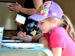 Kevin Hampson/Daily Herald-Tribune
Brooklyn Fulmek and fellow Harry Balfour Grade 1 students paint pictures during an activity at the Grande Prairie Children’s Festival in the Muskoseepi Park pavilion on Wednesday May 23 in Grande Prairie.