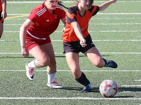 Sidney Turcotte, left, of St. Charles Cardinals, and Kaity Macgirr, of Lasalle Lancers, chase after the ball during action at the girls high school soccer final at James Jerome Sports Complex in Sudbury, Ont. on Tuesday May 29, 2018. John Lappa/Sudbury Star/Postmedia Network