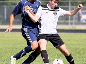 Ursuline Lancers' Rylan Burm, left, and Northern Vikings' Matt Dunn battle for the ball in the second half of the LKSSAA AAA senior boys' soccer final at Ursuline College Chatham in Chatham, Ont., on Tuesday, May 29, 2018. (MARK MALONE/Chatham Daily News/Postmedia Network)