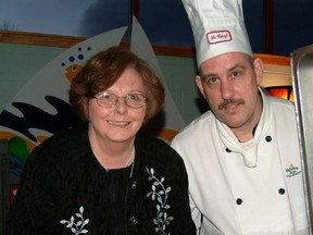 Ella-Jean Richter gets a peek of rosemary encrusted lamb chops prepared by Charles Crouthers, chef at Bridges at Holiday Inn, in this 2005 photo. Richter, who was vice-chair of Sault College's board of governors at the time, was taking part in Savour the Night, a college fundraiser.  (Sault Star File Photo)