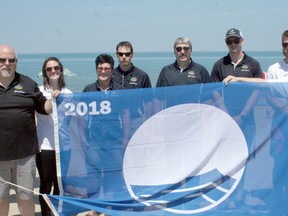 The Blue Flag is flying at the Grand Bend Beach, Marina and Port Franks Marina for the tenth consecutive year. To mark the achievement, which recognizes things such as water quality, education, environmental management and safety, the Blue Flag was officially raised at the Grand Bend Beach last Friday. Pictured from left are Lambton Shores Ward 2 Coun. Dan Sageman, facilitator of recreation and leisure Ashley Farr, Grand Bend beach manager Yvonne Desjardine, parks and facilities manager Randy Shaw, director of community services Steve McAuley, Grand Bend harbour master Josh Majerle, beach captain Stephan Maag and Lambton Shores Deputy Mayor Doug Cook.(Scott Nixon/Exeter Lakeshore Times-Advance)