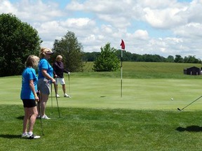 The second annual Charity Golf Tournament hosted by Pfaff Electric will take place on June 20. Above golfers Debra Laporte (front), Mhairi Walsh (middle) and tournament organizer Karen Pfaff (furthest back) watch as Victoria Pfaff (right) chips her shot onto the green at Ironwood Golf Club at last year’s tournament. (File photo/Exeter Lakeshore Times-Advance)